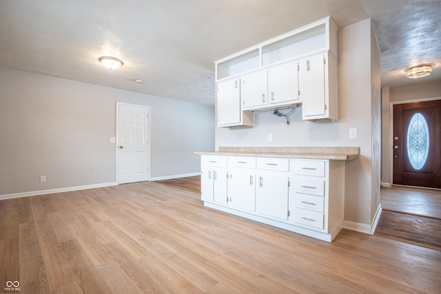 kitchen featuring white cabinets and light hardwood / wood-style floors