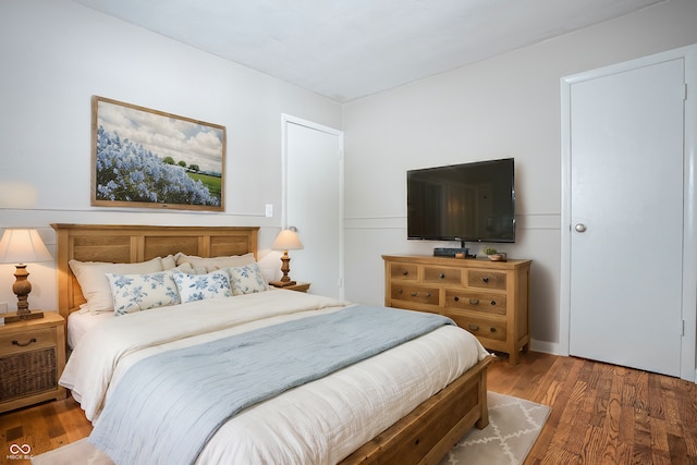 bedroom with dark hardwood / wood-style floors