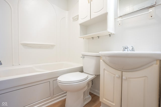 bathroom with hardwood / wood-style floors, vanity, and toilet