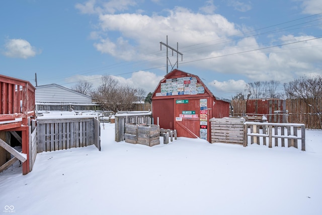 yard covered in snow featuring a shed