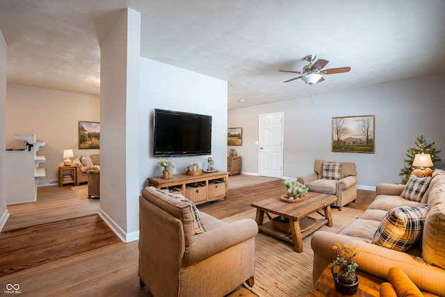 living room featuring light hardwood / wood-style flooring and ceiling fan