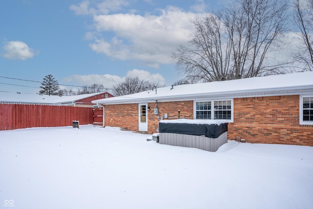 snow covered house with a hot tub