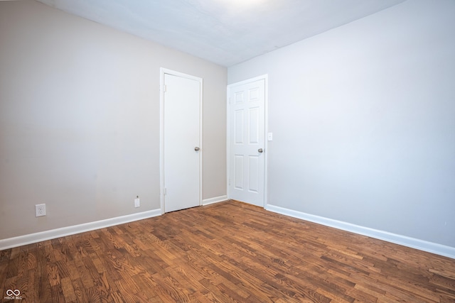 spare room featuring dark hardwood / wood-style flooring