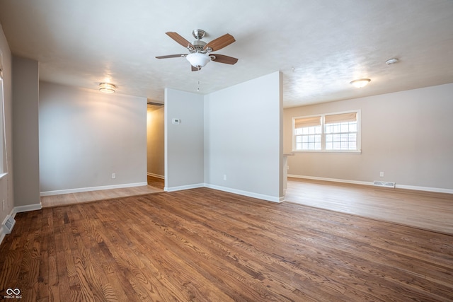 unfurnished room with ceiling fan and wood-type flooring