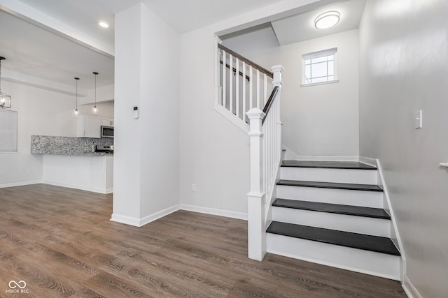 staircase featuring hardwood / wood-style flooring