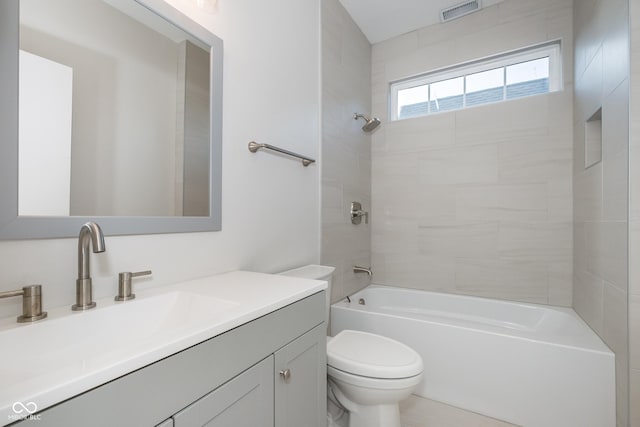 full bathroom with vanity, tiled shower / bath combo, and toilet