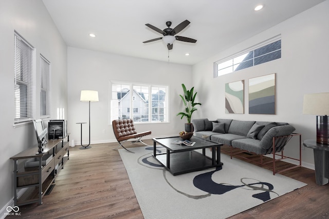 living room featuring hardwood / wood-style flooring and ceiling fan