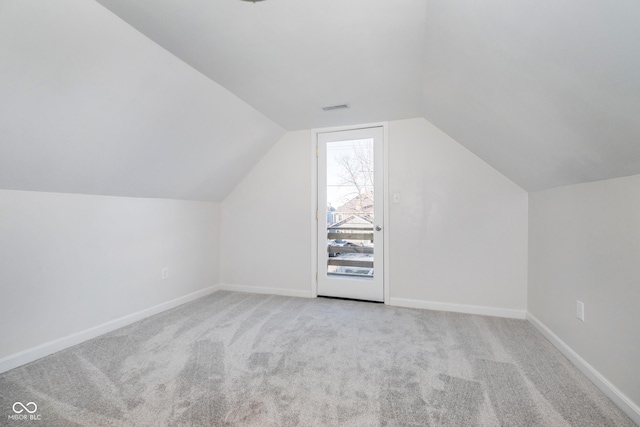 bonus room featuring light colored carpet and lofted ceiling