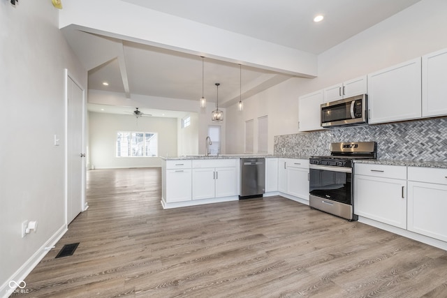 kitchen featuring ceiling fan, white cabinetry, kitchen peninsula, and appliances with stainless steel finishes