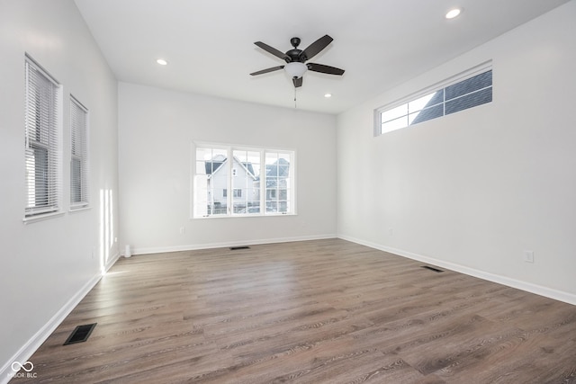 spare room featuring ceiling fan and dark hardwood / wood-style flooring