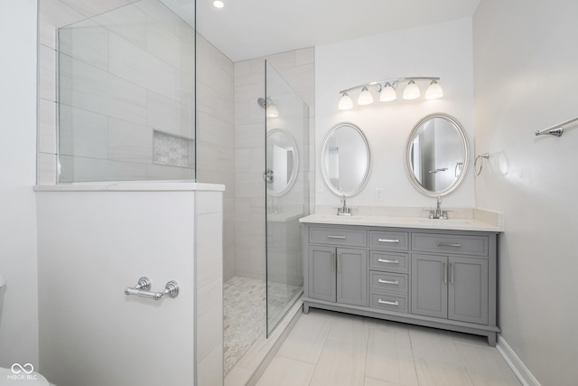 bathroom with vanity and tiled shower