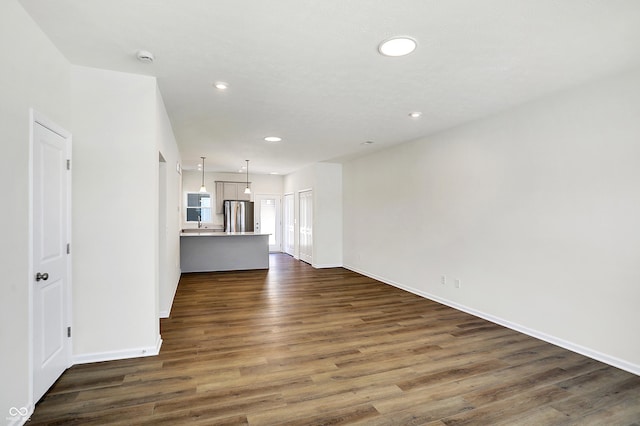 unfurnished living room with dark wood-type flooring