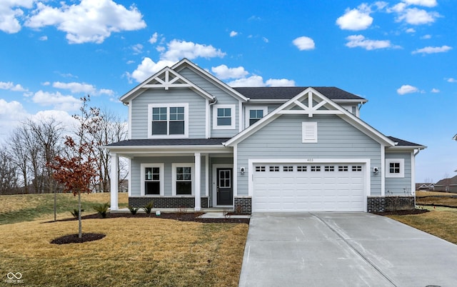 craftsman-style house featuring a front yard and covered porch