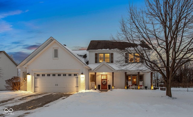 view of front of home featuring a garage and a porch