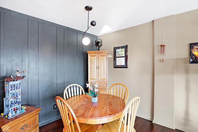 dining space with dark hardwood / wood-style floors