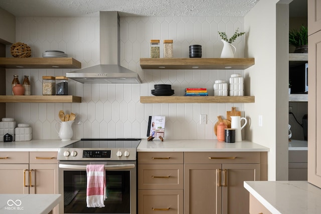 kitchen featuring stainless steel range with electric cooktop, wall chimney exhaust hood, and backsplash