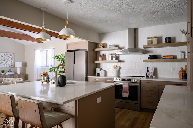 kitchen featuring a center island, wall chimney exhaust hood, decorative backsplash, hanging light fixtures, and appliances with stainless steel finishes