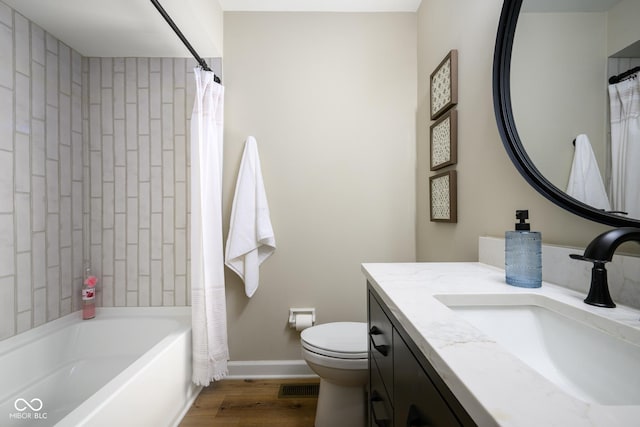 full bathroom featuring toilet, hardwood / wood-style flooring, shower / bath combination with curtain, and vanity