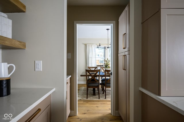 interior space with light hardwood / wood-style floors and an inviting chandelier