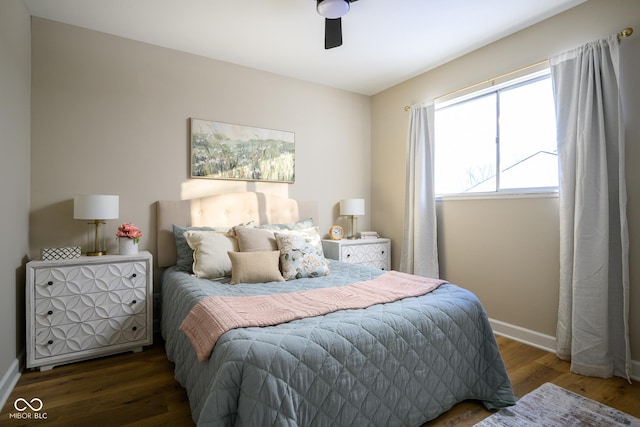 bedroom with ceiling fan and dark hardwood / wood-style floors