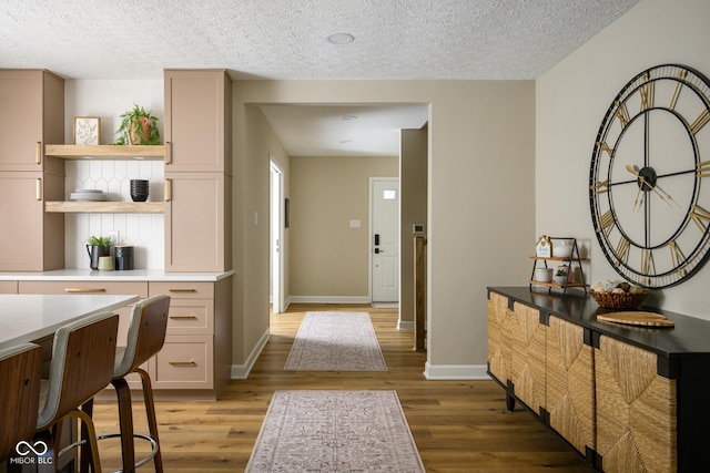 interior space featuring a textured ceiling and wood-type flooring