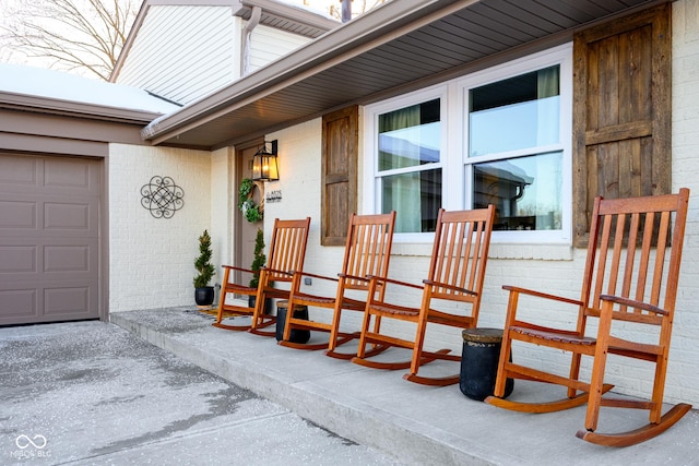 view of patio with a garage and covered porch