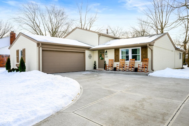 view of front of property with a porch and a garage