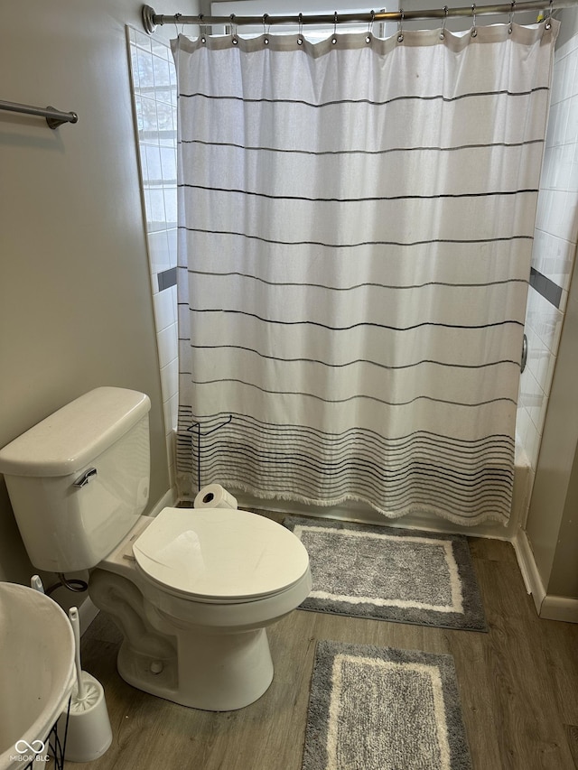 bathroom featuring hardwood / wood-style floors and toilet