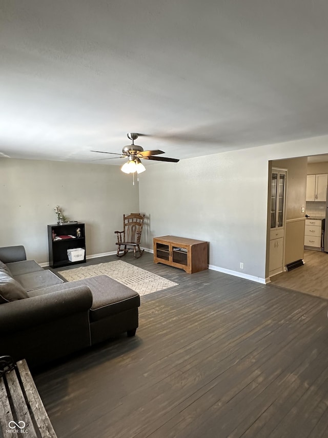 living room featuring dark hardwood / wood-style flooring and ceiling fan