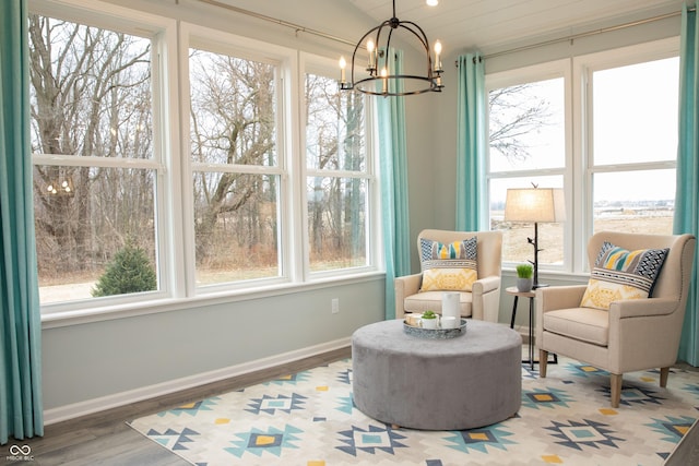 sunroom featuring a chandelier