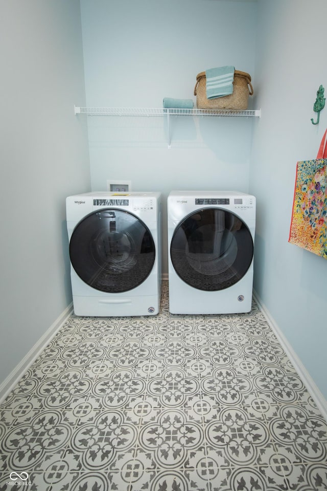 laundry area featuring separate washer and dryer and light tile patterned floors