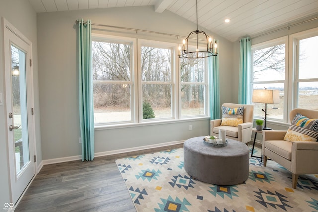 sunroom with lofted ceiling with beams and a chandelier