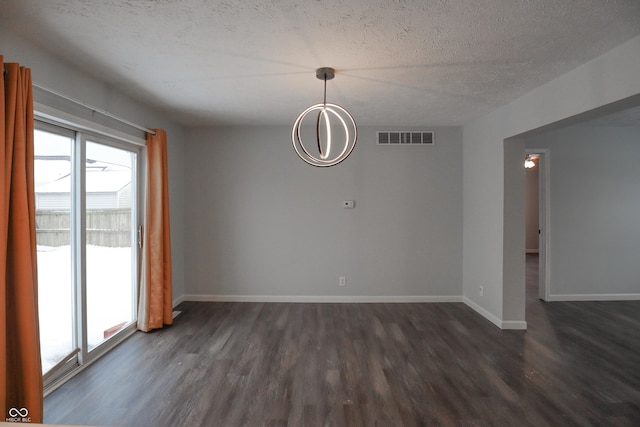 unfurnished room with dark hardwood / wood-style floors and a textured ceiling