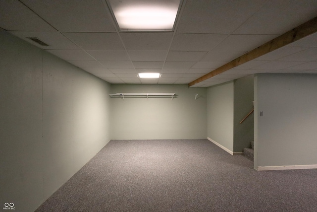 basement featuring carpet floors and a drop ceiling