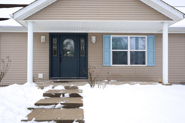 view of snow covered property entrance