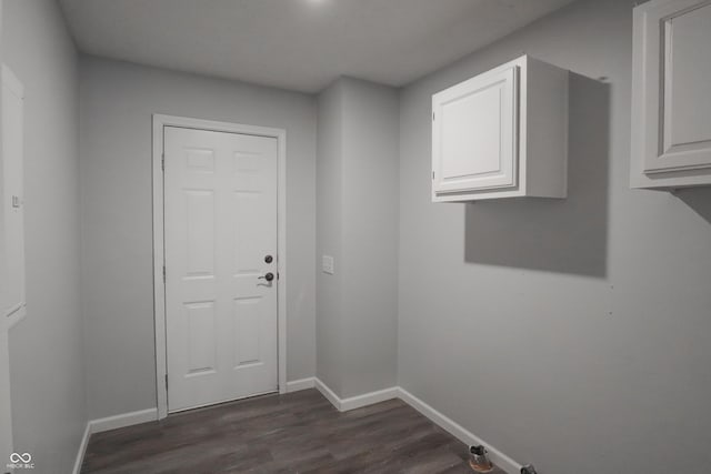 laundry area with cabinets and dark hardwood / wood-style floors