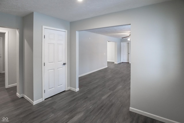 hallway featuring dark hardwood / wood-style floors and a textured ceiling