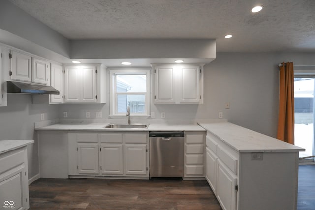 kitchen with white cabinetry, kitchen peninsula, and sink