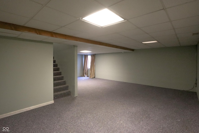 basement featuring carpet flooring and a drop ceiling