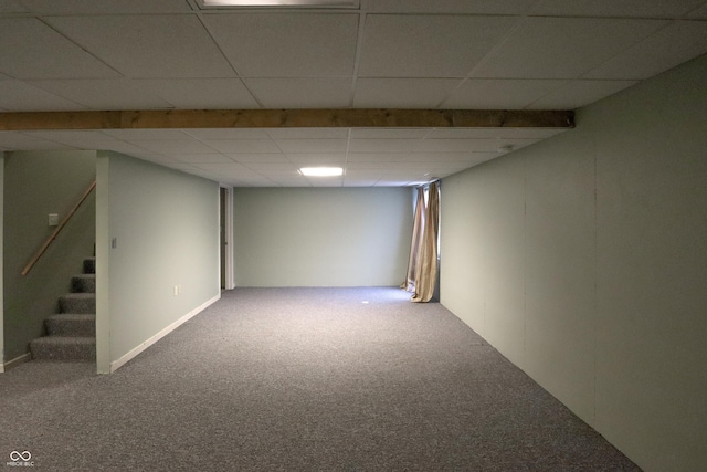 basement with carpet floors and a paneled ceiling