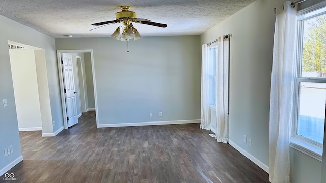 unfurnished room with ceiling fan, dark hardwood / wood-style floors, and a textured ceiling