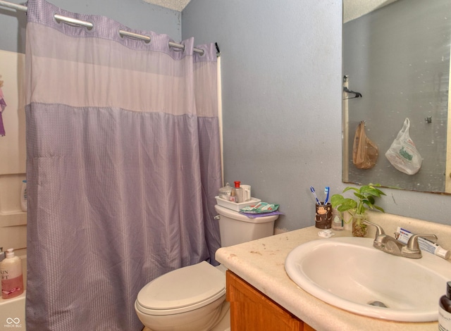 full bathroom with shower / bath combo with shower curtain, a textured ceiling, toilet, and vanity