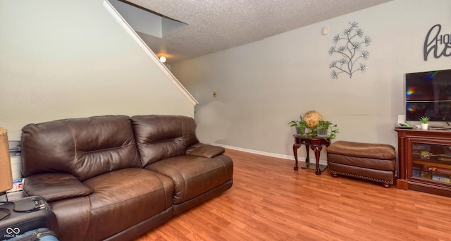 living room featuring a textured ceiling and hardwood / wood-style floors