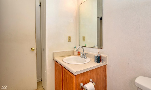 bathroom with toilet and vanity