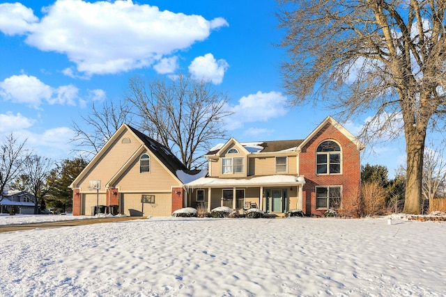 view of front of property featuring covered porch and a garage