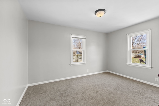 carpeted empty room with baseboards