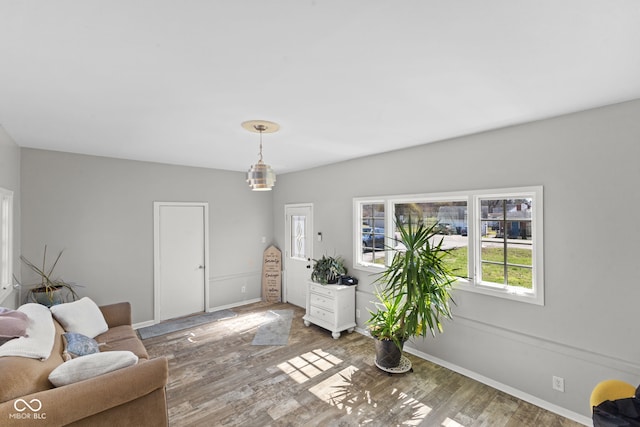 interior space featuring baseboards and wood finished floors