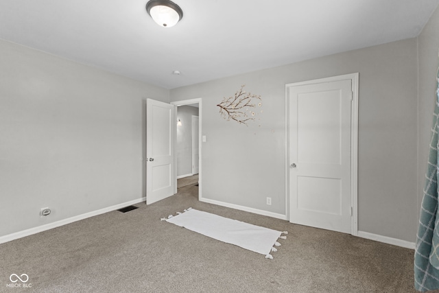 unfurnished bedroom featuring baseboards and carpet