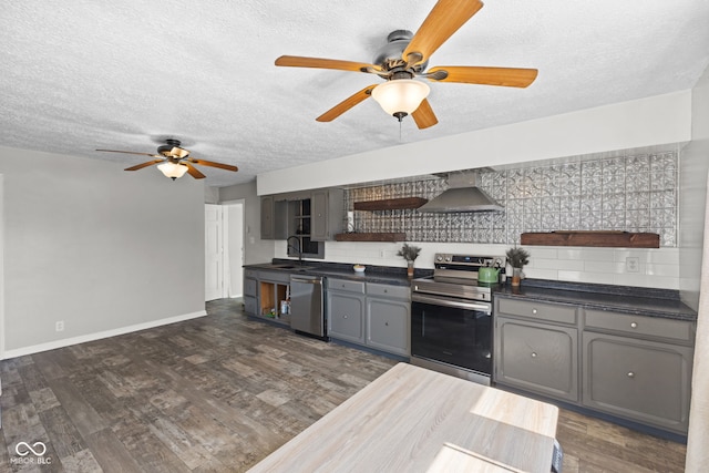 kitchen featuring dark countertops, a ceiling fan, appliances with stainless steel finishes, open shelves, and gray cabinetry