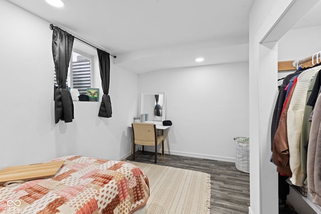 bedroom with baseboards, wood finished floors, and recessed lighting